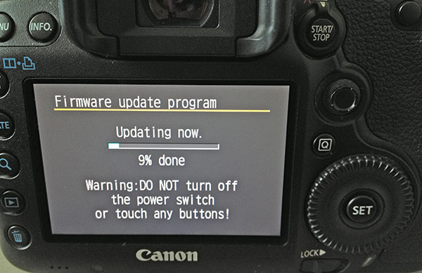 A firmware update in progress on an EOS DSLR camera